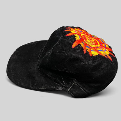 Raree Finds vintage Unicas Southwest black velvet cap with a colorful embroidered sun face motif on the crown.