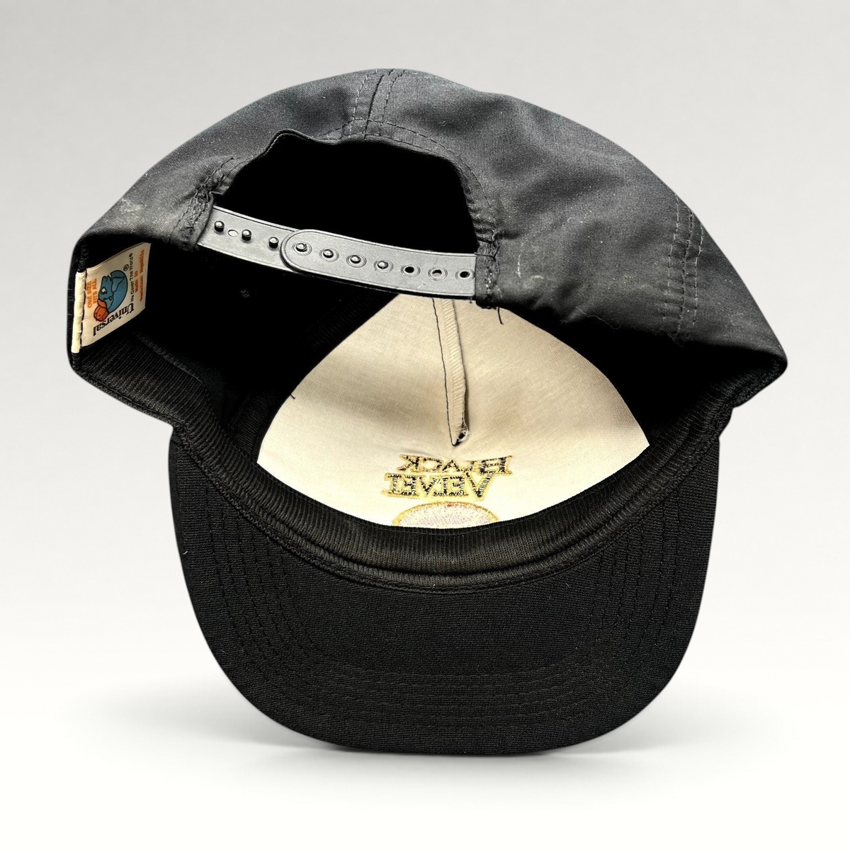 Raree Finds vintage Black Velvet Whisky snapback hat showing the interior label and adjustable plastic strap