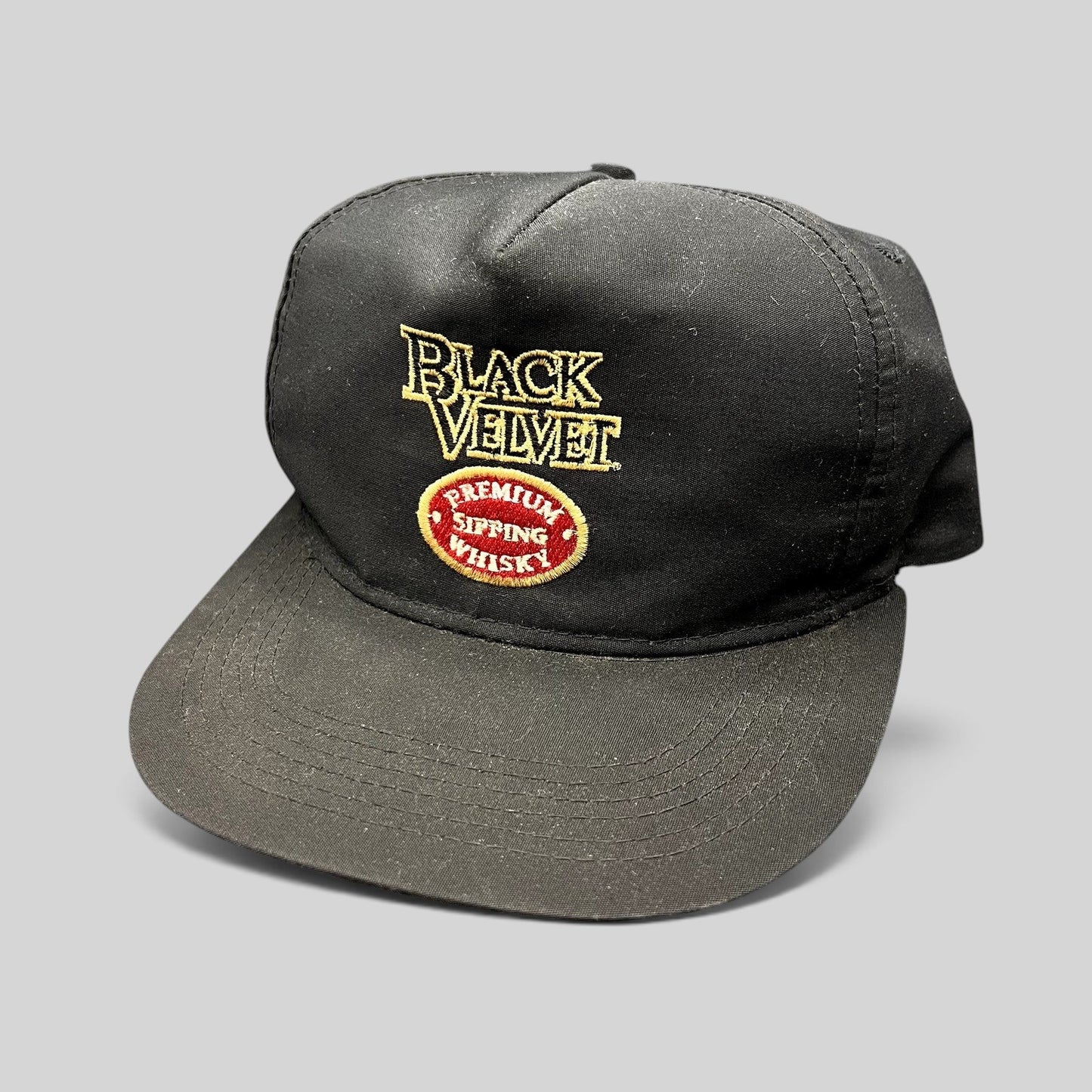 Raree Finds vintage black snapback hat with embroidered Black Velvet Premium Blended Whisky logo and red crest