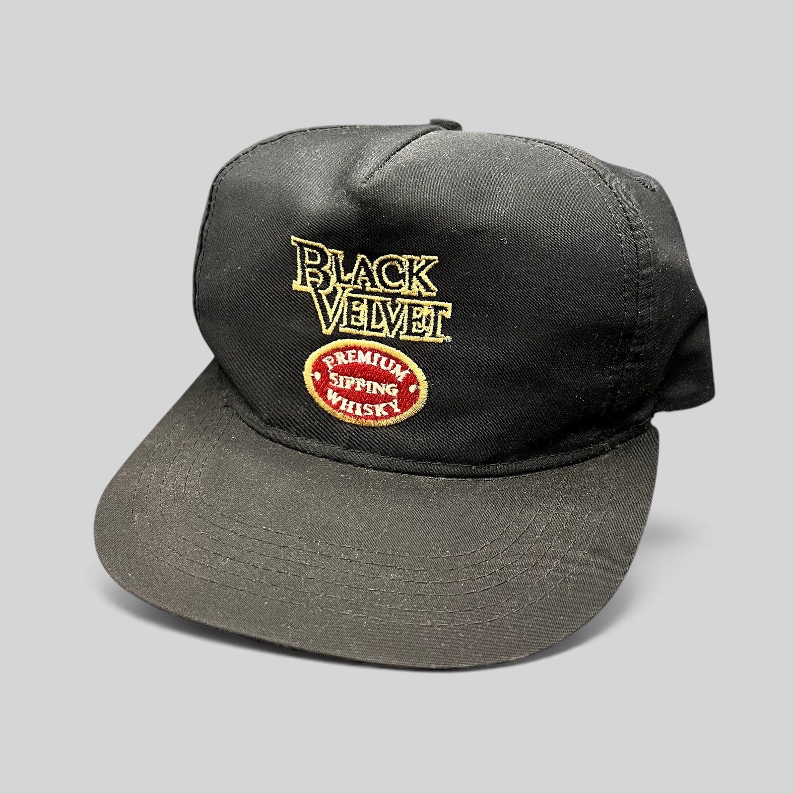 Raree Finds vintage black snapback hat with embroidered Black Velvet Premium Blended Whisky logo and red crest