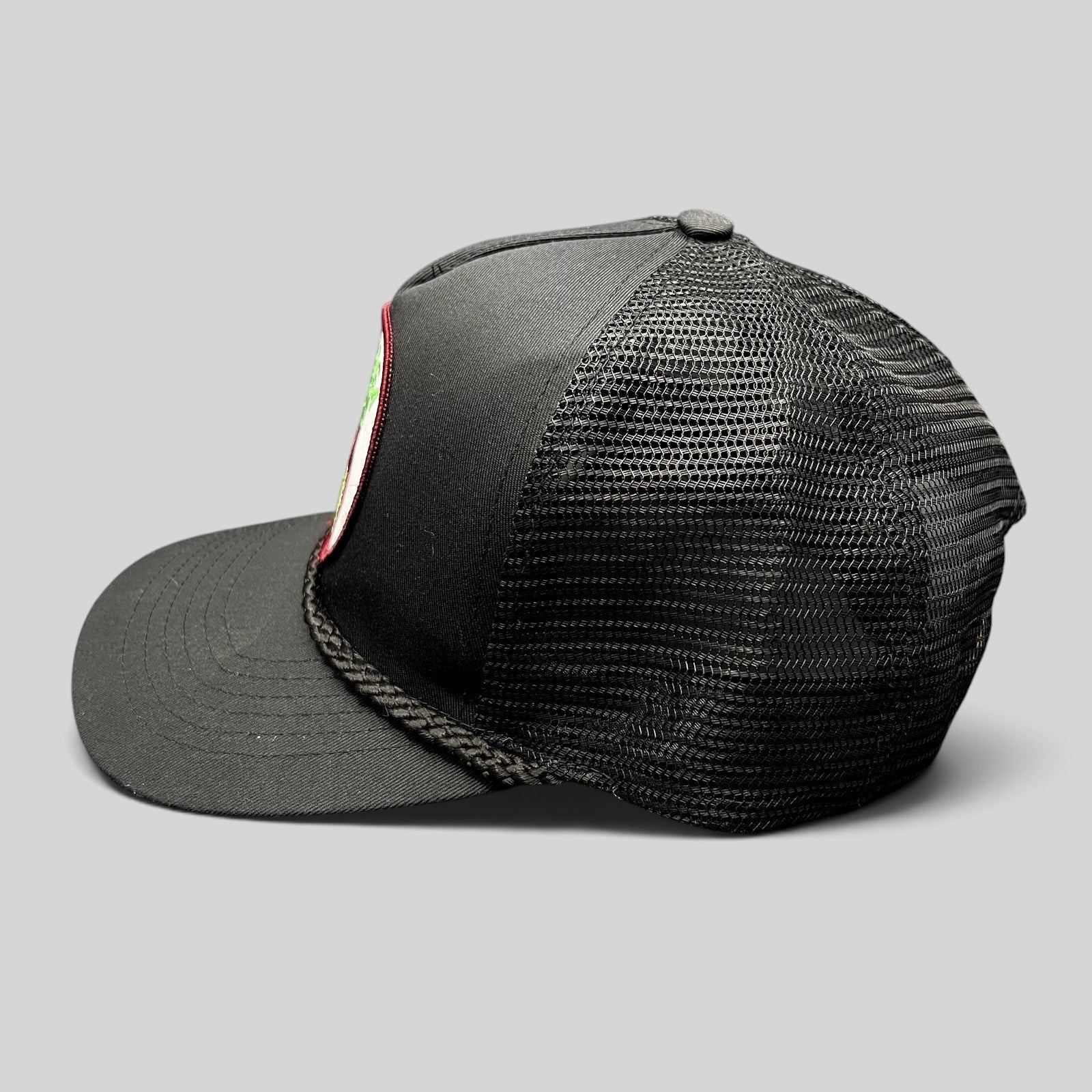 Raree Finds vintage black Calistoga Wine trucker hat with mesh back, braided rope brim, and embroidered grape patch.