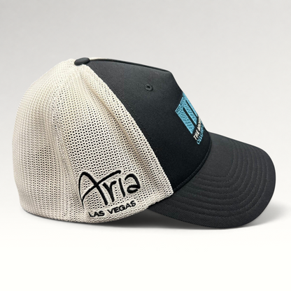 Raree Finds black and white mesh Flexfit golf hat featuring Aria Las Vegas embroidery and MJ Invitational logo