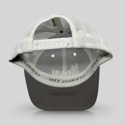 Raree Finds The Movie Guys black and white Flexfit 110 trucker hat with adjustable snapback and breathable mesh back