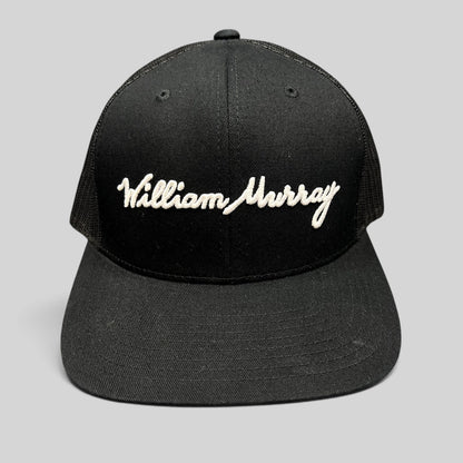 Raree Finds black William Murray Golf trucker hat with white script logo embroidery and structured mesh back