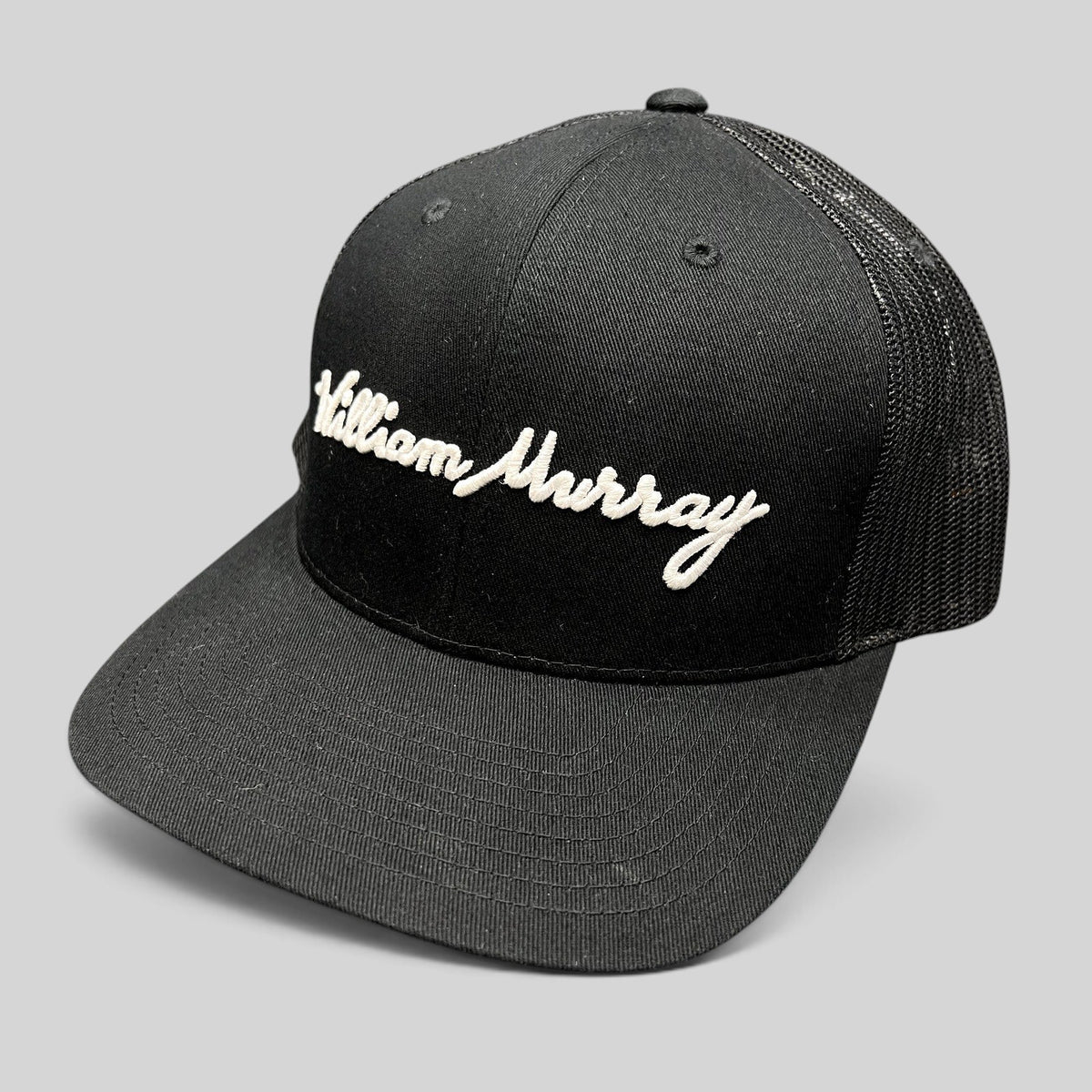 Raree Finds black William Murray Golf trucker hat with white script logo embroidery and mesh back panels