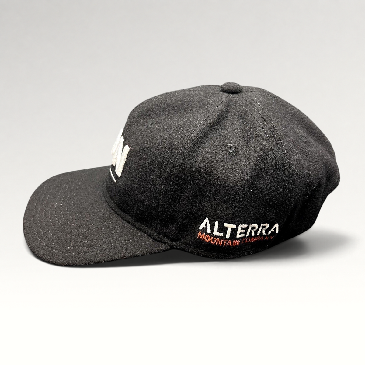 Raree Finds black wool-blend Ikon Pass strapback hat with white Alterra Mountain Company embroidery on the side