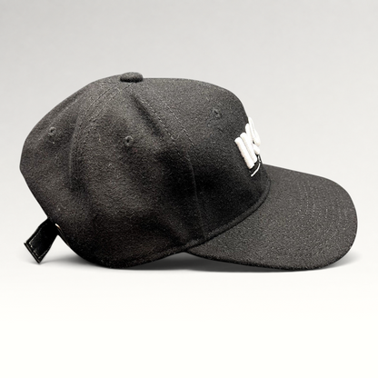 Raree Finds black wool-blend Ikon Pass strapback hat with white embroidered logo and adjustable leather-style strap.
