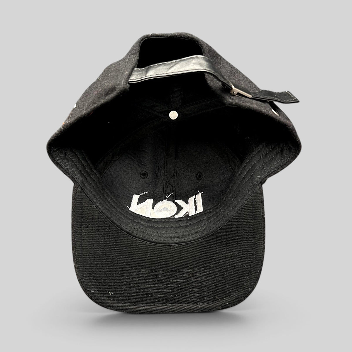 Raree Finds black wool-blend Ikon Pass strapback hat with white embroidered logo and adjustable leather-style strap