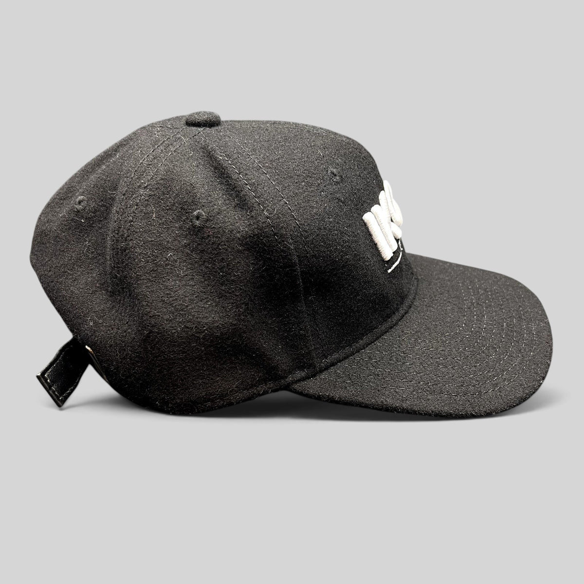 Raree Finds black wool-blend strapback hat with white Ikon Pass embroidery and adjustable leather-style strap