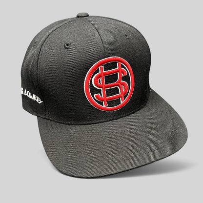 Raree Finds black Yupoong snapback hat with red embroidered P$ logo and side text on a flat brim structured cap