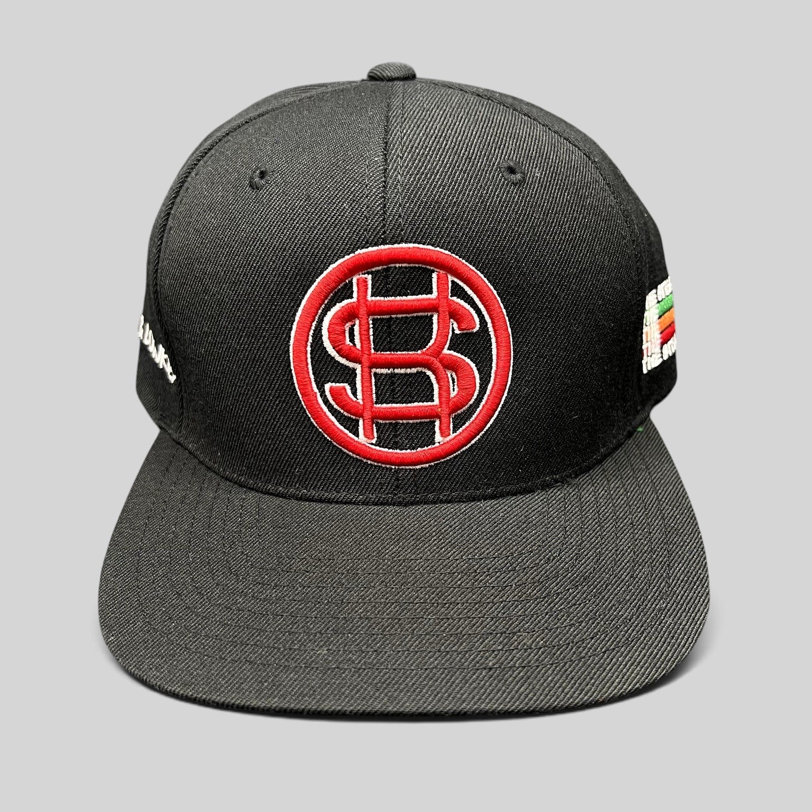 Raree Finds black Yupoong snapback hat with red and white embroidered P$ logo and side text embroidery.