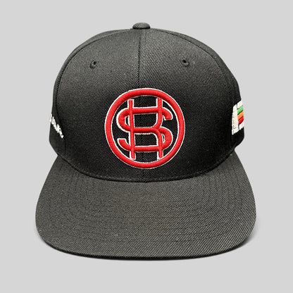 Raree Finds black Yupoong snapback hat with red and white embroidered P$ logo and side text embroidery.