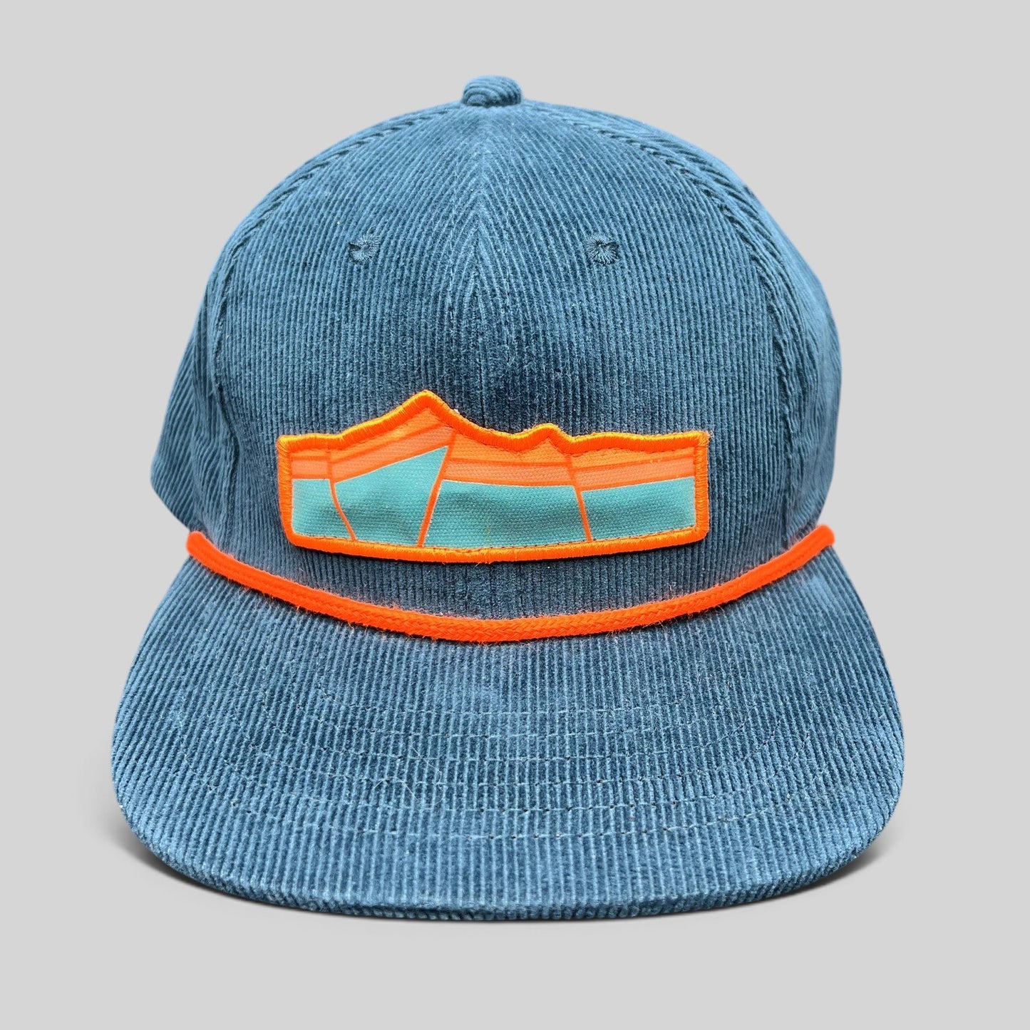 Raree Finds blue corduroy snapback hat with orange rope detail and mountain landscape embroidered patch logo