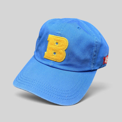 Raree Finds royal blue cotton dad cap with a yellow chenille B appliqué on the front against a black background.
