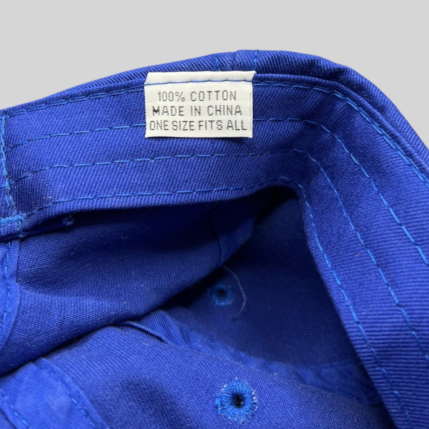 Raree Finds vintage royal blue cotton golf hat interior tag showing 100 percent cotton and one size fits all details