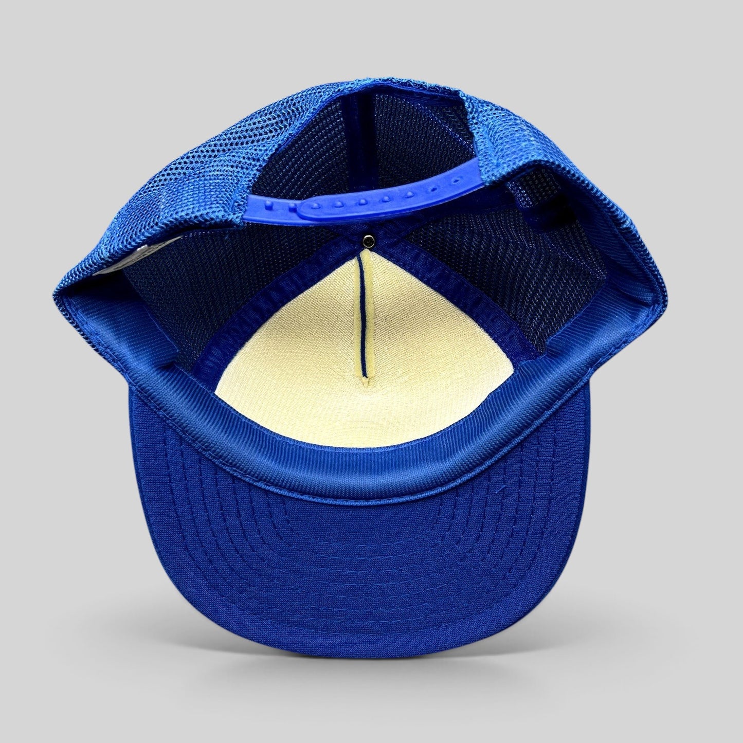 Raree Finds vintage royal blue mesh trucker hat with adjustable snapback closure, interior view