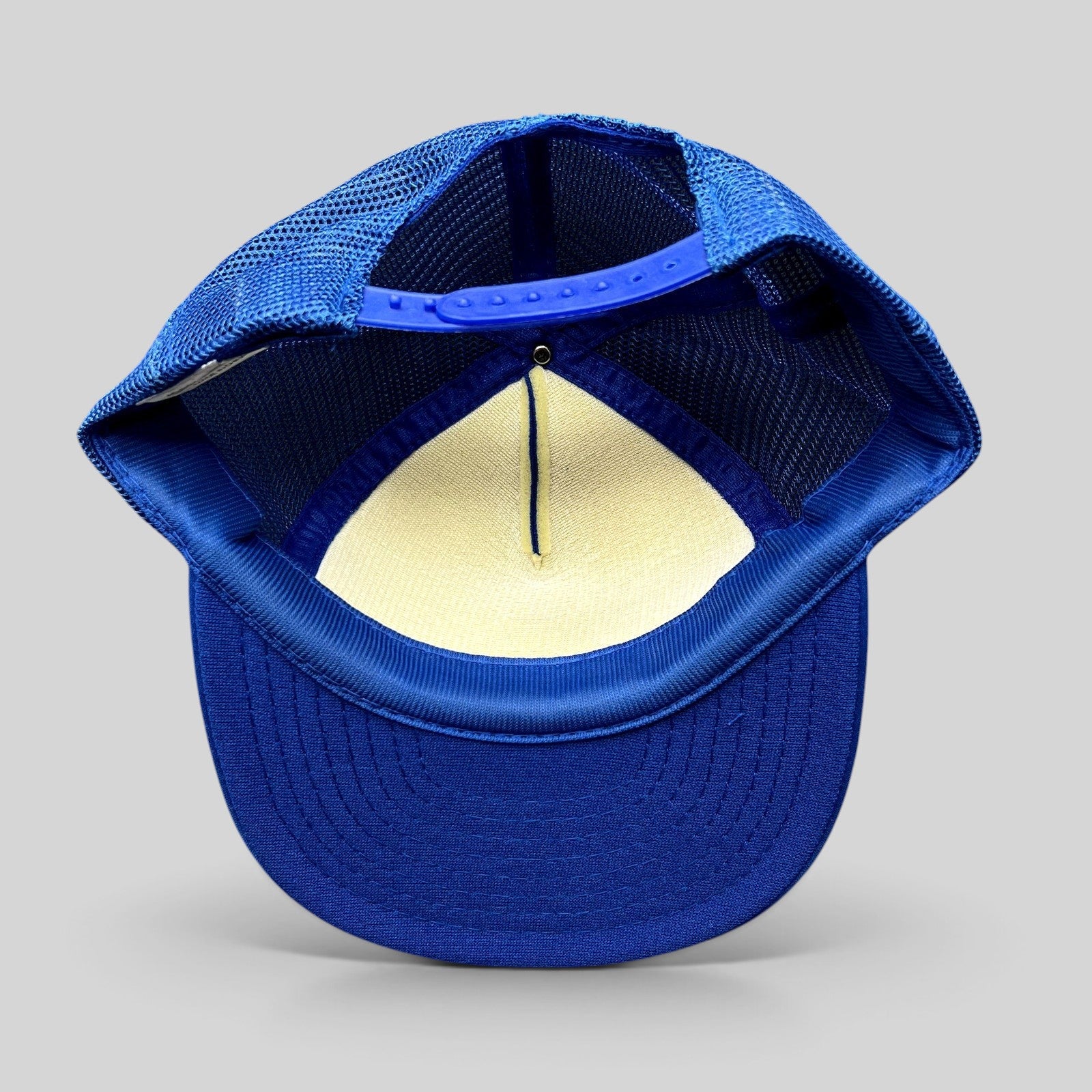 Raree Finds vintage royal blue mesh trucker hat with adjustable snapback closure, interior view