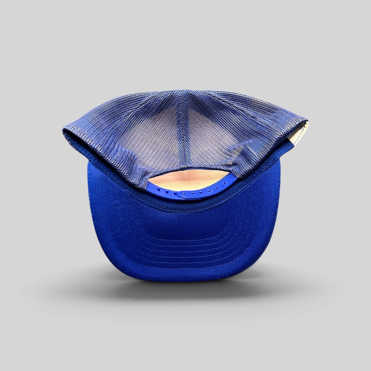 Raree Finds vintage royal blue mesh trucker hat with adjustable snapback closure, back view