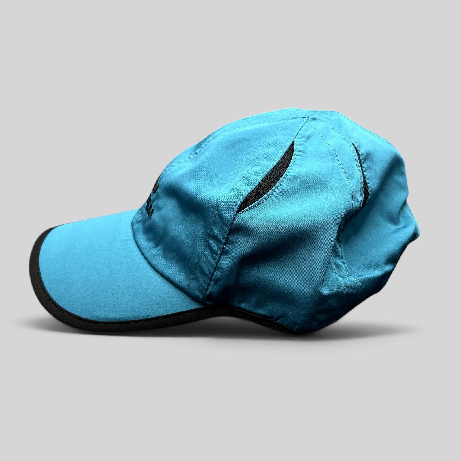Raree Finds blue lightweight polyester performance running hat with black trim and embroidered logo side view