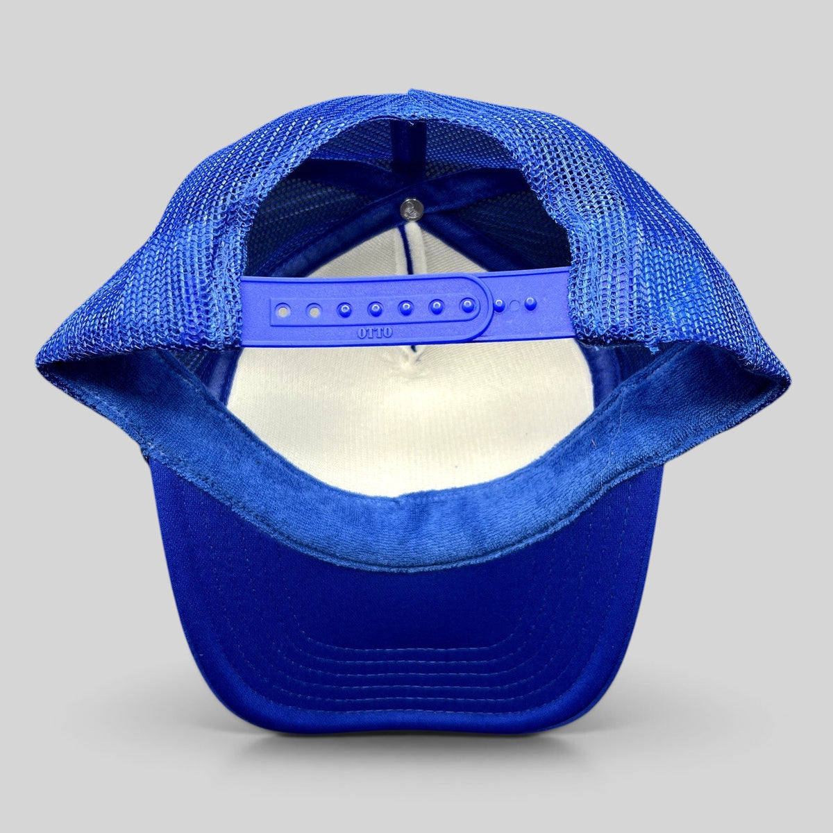 Raree Finds royal blue Otto foam trucker hat with adjustable snapback closure and mesh back, rear view.