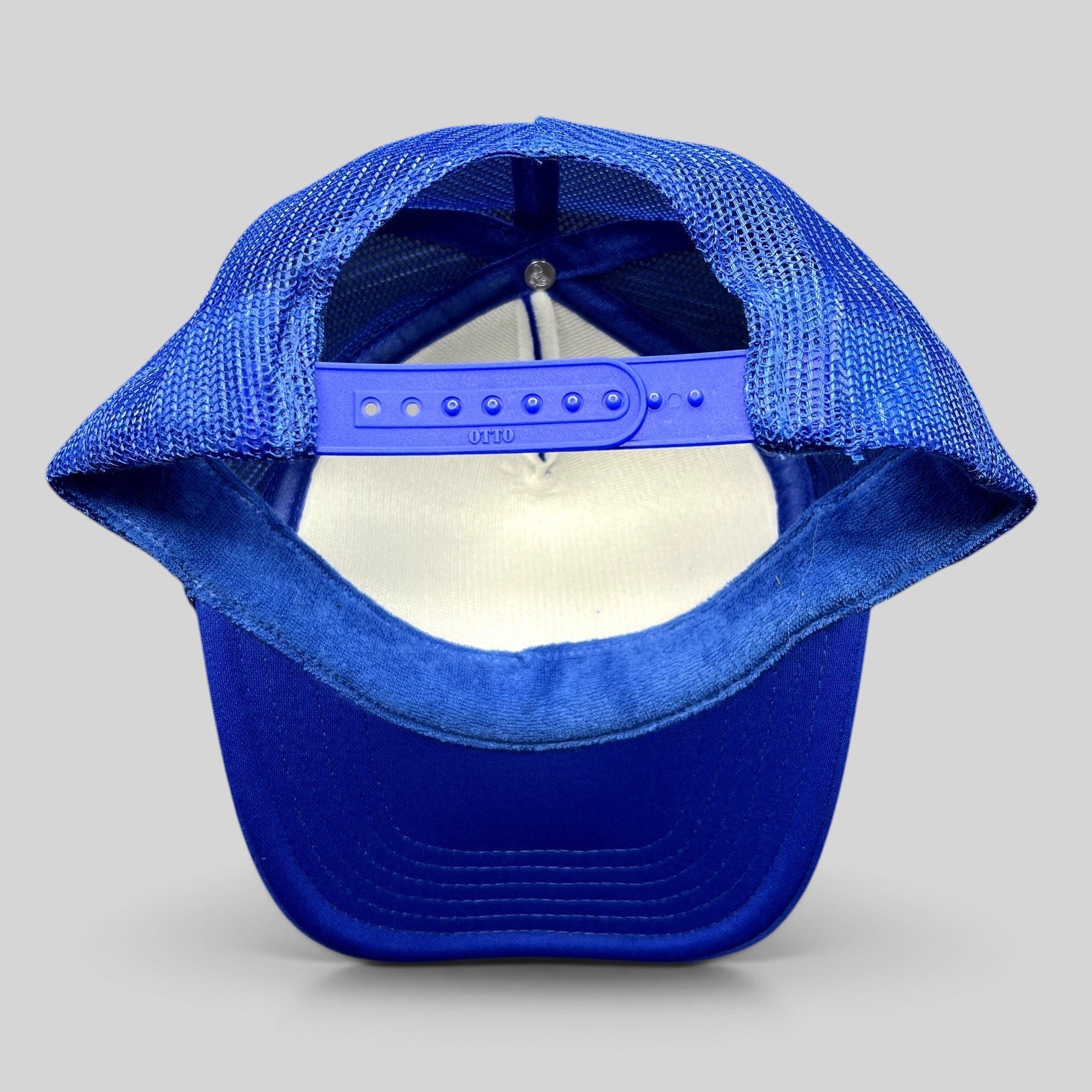 Raree Finds royal blue Otto foam trucker hat with adjustable snapback closure and mesh back, rear view.