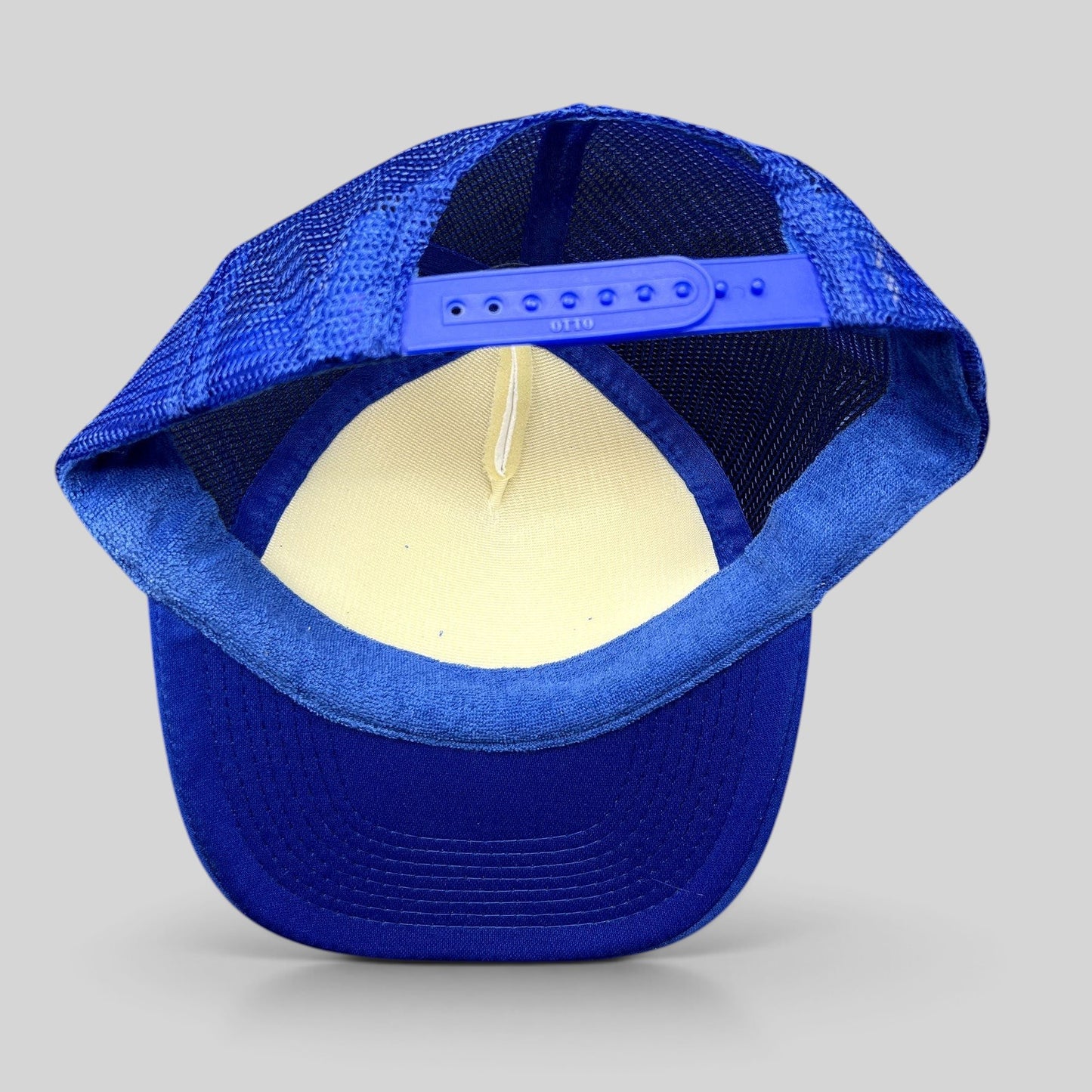 Raree Finds blue and white trucker snapback hat with mesh back and adjustable plastic strap, rear view