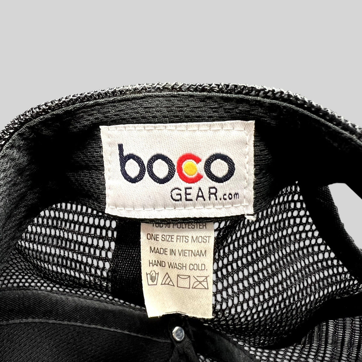 Raree Finds Boco Gear trucker hat interior tag showing brand logo, material composition, and care instructions.