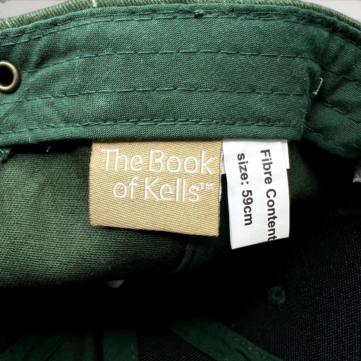 Raree Finds The Book of Kells dark green hat interior label showing size 59cm and official branding