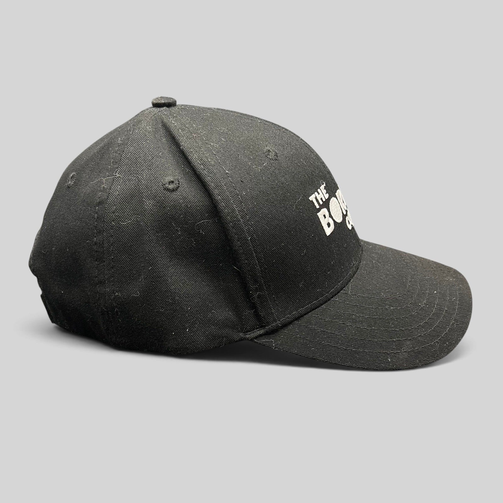 Raree Finds black The Boring Company strapback hat with white embroidered logo on a structured cotton crown