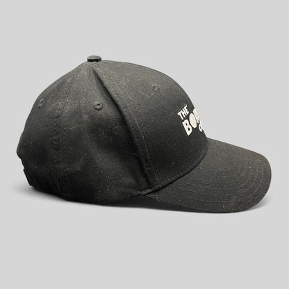 Raree Finds black The Boring Company strapback hat with white embroidered logo on a structured cotton crown