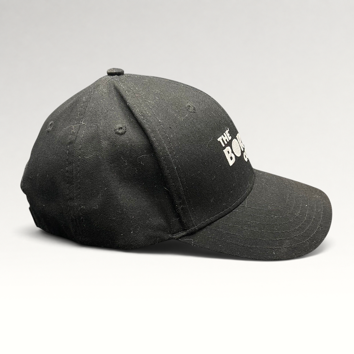 Raree Finds black The Boring Company strapback hat with white embroidered logo on a structured cotton crown