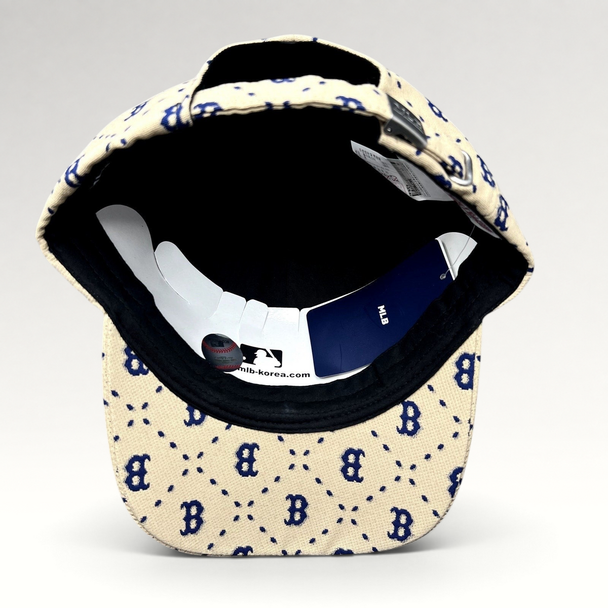 Raree Finds MLB Korea Boston Red Sox strapback hat in beige with blue monogram pattern and adjustable metal closure.