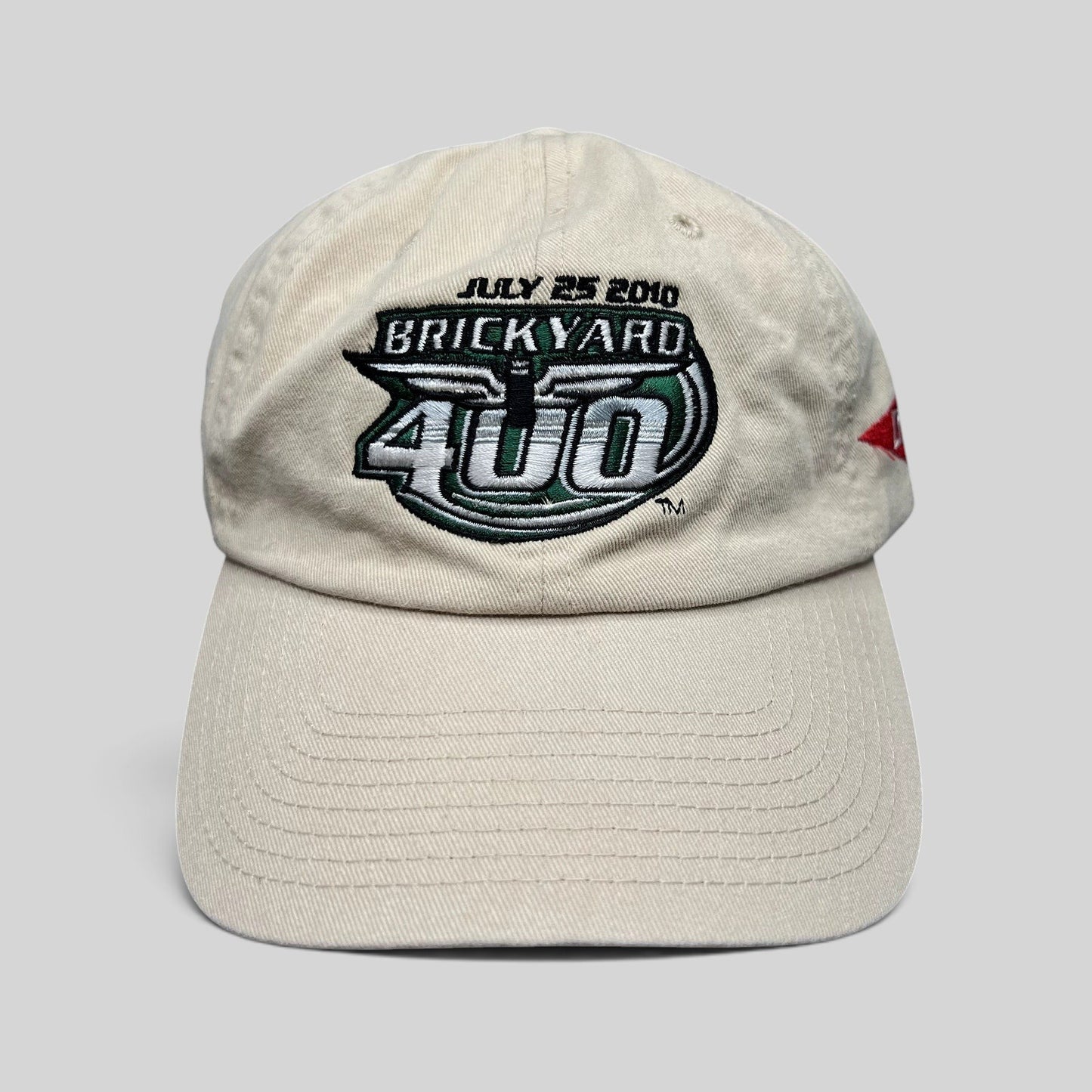 Raree Finds cream cotton 2010 Brickyard 400 NASCAR strapback hat with embroidered event logo and date