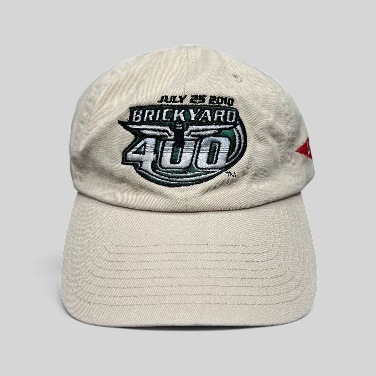 Raree Finds cream cotton 2010 Brickyard 400 NASCAR strapback hat with embroidered event logo and date