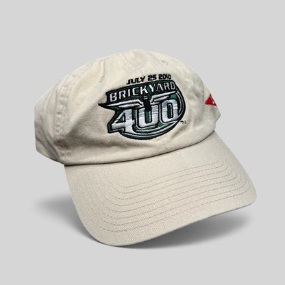 Raree Finds cream cotton 2010 Brickyard 400 NASCAR strapback hat with embroidered event logo on front
