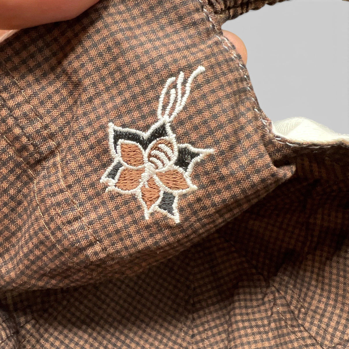 Raree Finds The Broadmoor golf hat featuring brown micro-check lining with detailed floral embroidery under the brim