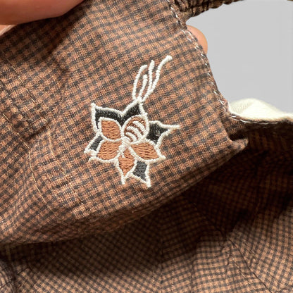 Raree Finds The Broadmoor golf hat featuring brown micro-check lining with detailed floral embroidery under the brim