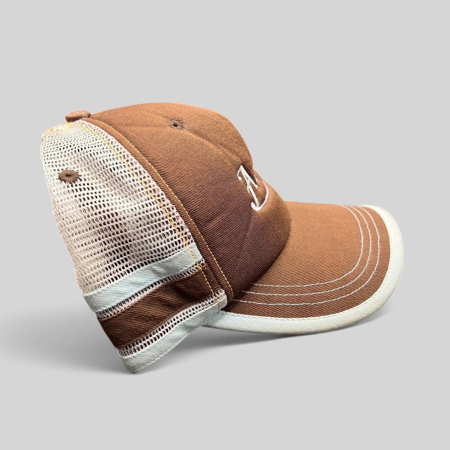 Raree Finds brown Aspen Colorado trucker hat with white mesh back, curved brim, and white script embroidery.