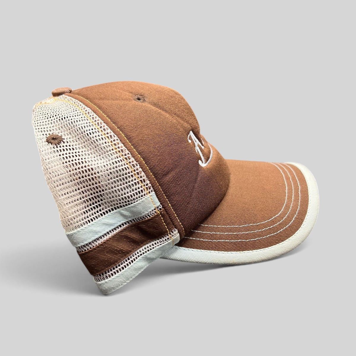 Raree Finds brown Aspen Colorado trucker hat with white mesh back, curved brim, and white script embroidery.