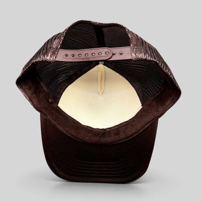Raree Finds brown and cream trucker snapback hat showing the interior mesh lining and adjustable plastic snap closure.