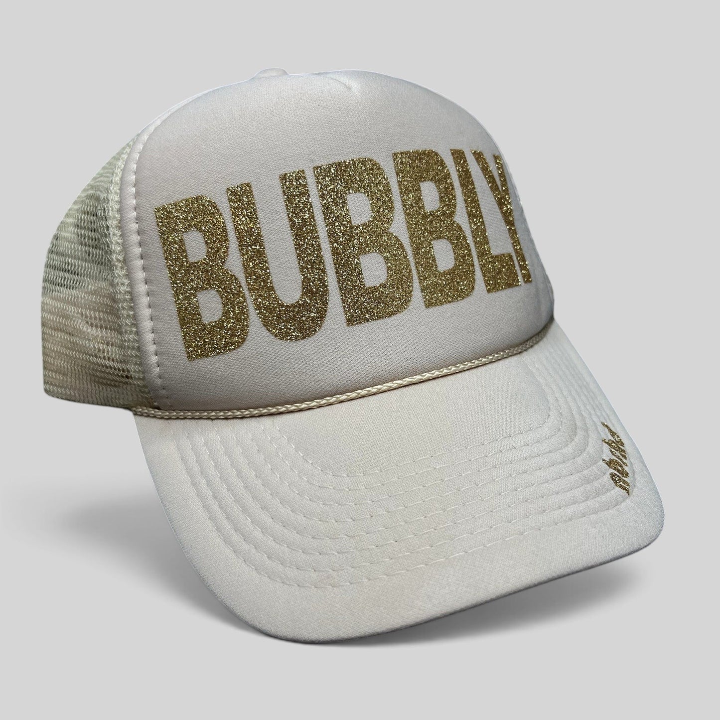 Raree Finds cream trucker hat with gold glitter BUBBLY text and mesh back, featuring NBRHD branding on the visor.