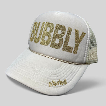 Raree Finds cream trucker hat with gold glitter BUBBLY lettering and NBRHD logo on the visor, mesh back snapback style.