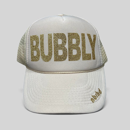 Raree Finds cream trucker hat with gold glitter BUBBLY text and NBRHD branding on the visor, mesh back snapback style.