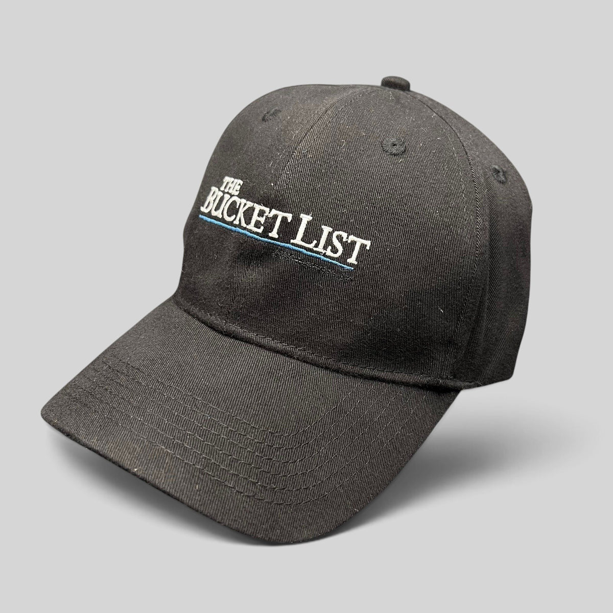 Raree Finds black cotton strapback hat featuring The Bucket List movie logo embroidered in white and blue