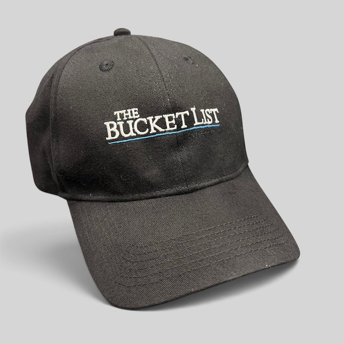 Raree Finds black cotton strapback hat featuring The Bucket List movie cast and crew embroidery in white and blue