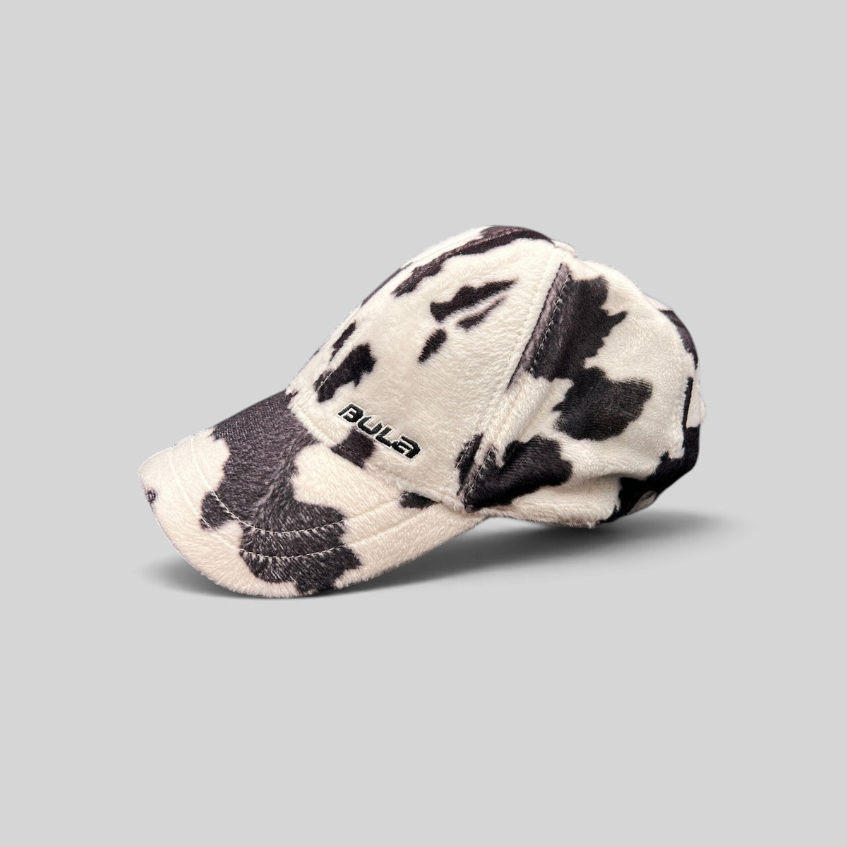 Raree Finds BULA black and white cow print plush fleece baseball cap with curved brim and side logo embroidery