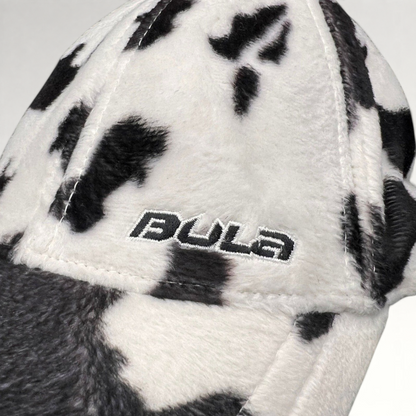 Raree Finds BULA black and white cow print plush fleece cap with embroidered side logo detail