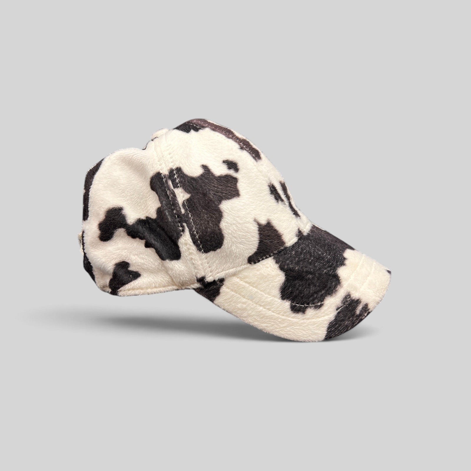 Raree Finds BULA black and white cow print plush fleece baseball cap with a curved brim and unstructured crown