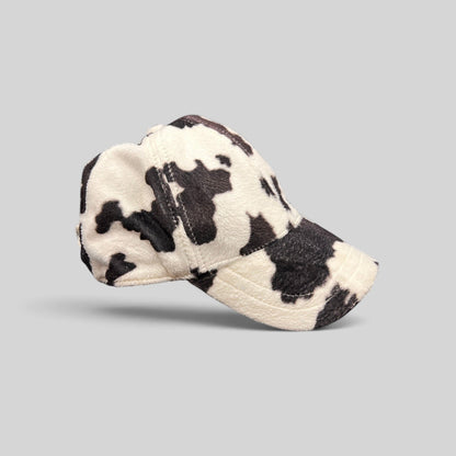Raree Finds BULA black and white cow print plush fleece baseball cap with a curved brim and unstructured crown