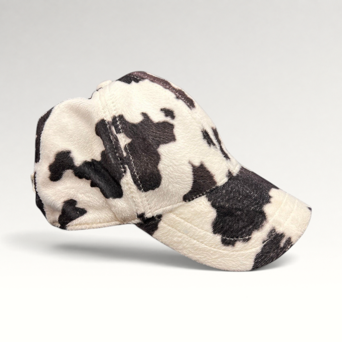 Raree Finds BULA black and white cow print plush fleece baseball cap with a curved brim and unstructured crown